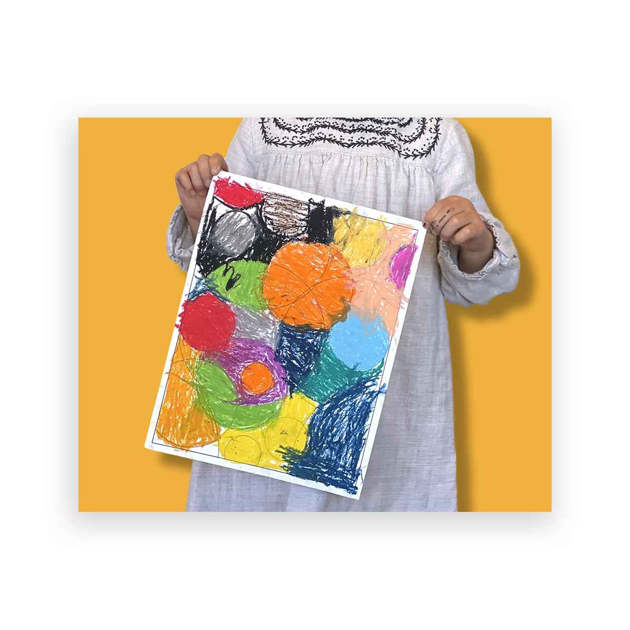 Child proudly holding a kandinsky painting, a result of our private art lessons